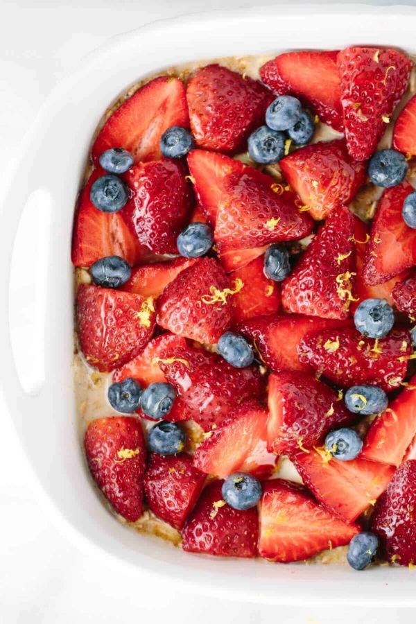 草莓和蓝莓放在烤盘中的燕麦片上