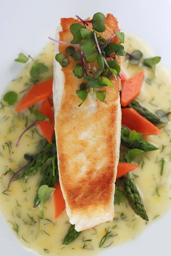 Golden crust halibut with garnish on top