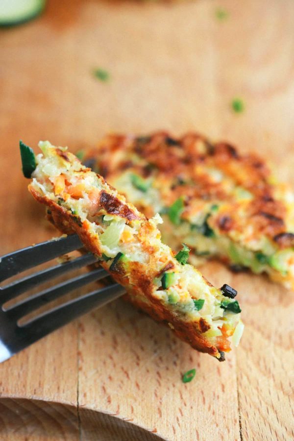 叉子拿着一半的蔬菜油炸物