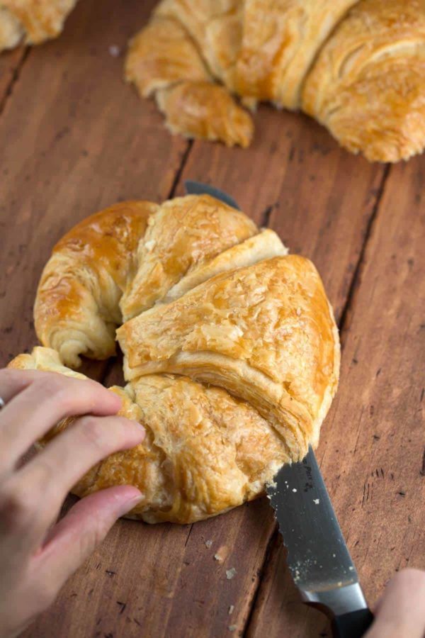 slicing a croissant in half