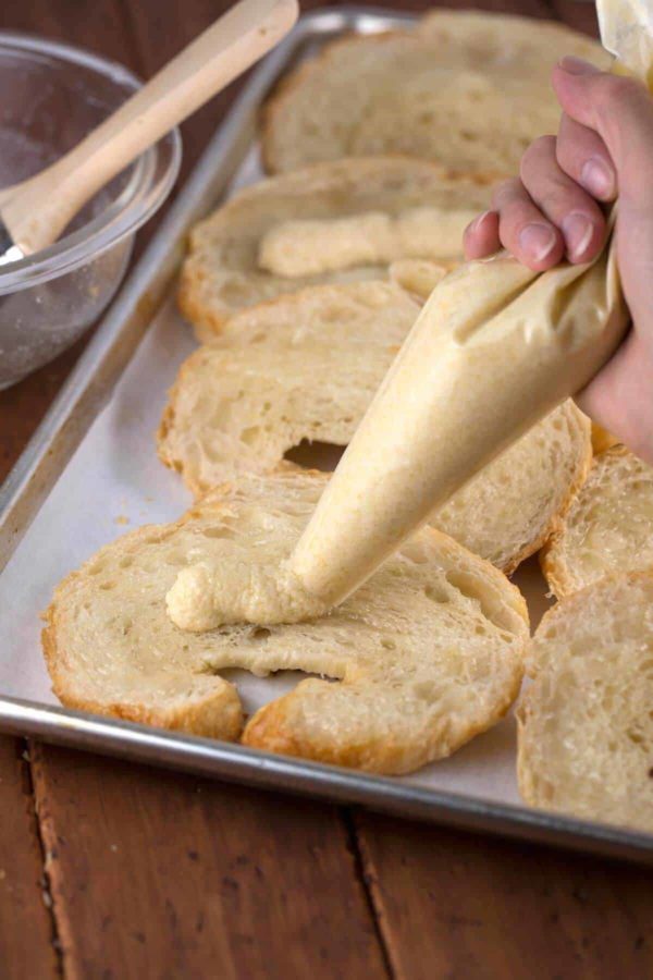 pipping a bag of filling into the croissants