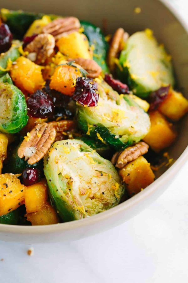 close up of brussels sprouts, walnuts, and cubes of butternut squash