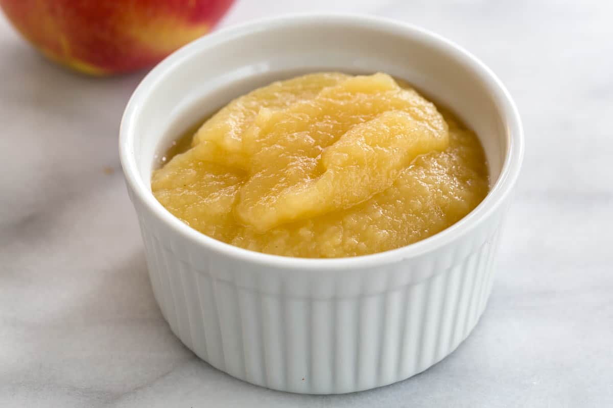 Apple sauce puree in a white ramekin.