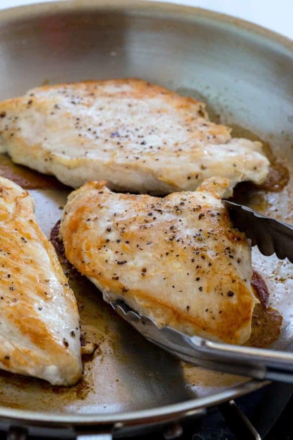 Sautéed chicken breasts in a frying pan