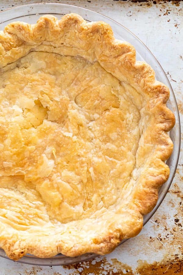 fully blind baked pie crust in a glass dish